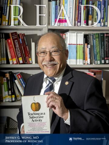 Jeffer G Wong, MD, professor of medicine holding a book "Teaching as a Subversive Activity"