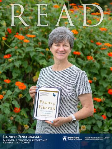 2018 Read Poster honoree Jennifer Fenstermaker holding the book: Proof of Heaven: A Neurosurgeons Journey into the Afterlife